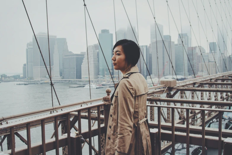 a young woman standing in front of a body of water