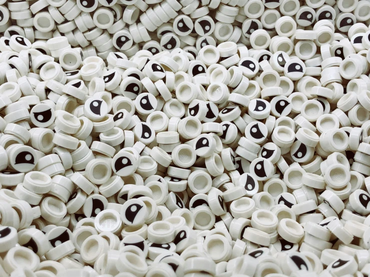 a number of white and black beads inside of a bowl