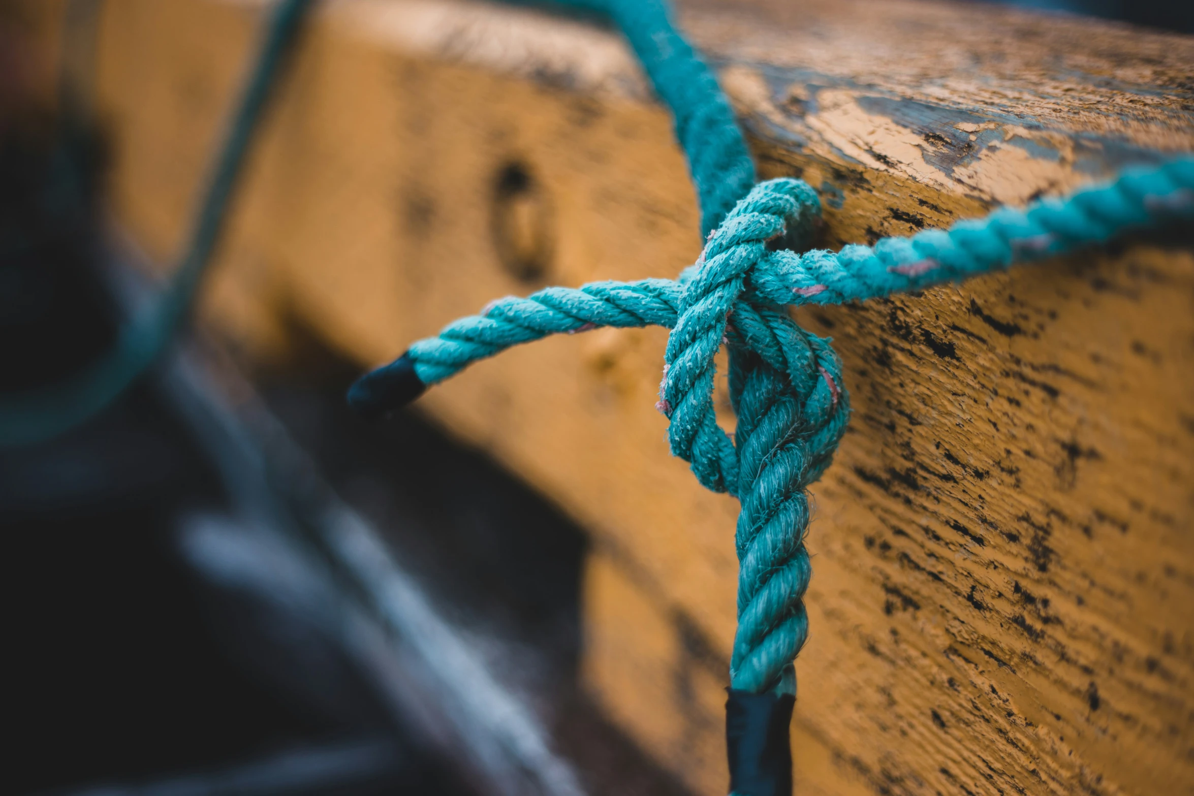 closeup of ropes tied together on a wooden boat