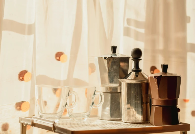 a wood table filled with lots of coffee machines