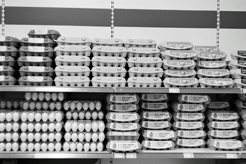 black and white po of eggs in different types and shapes on a shelf