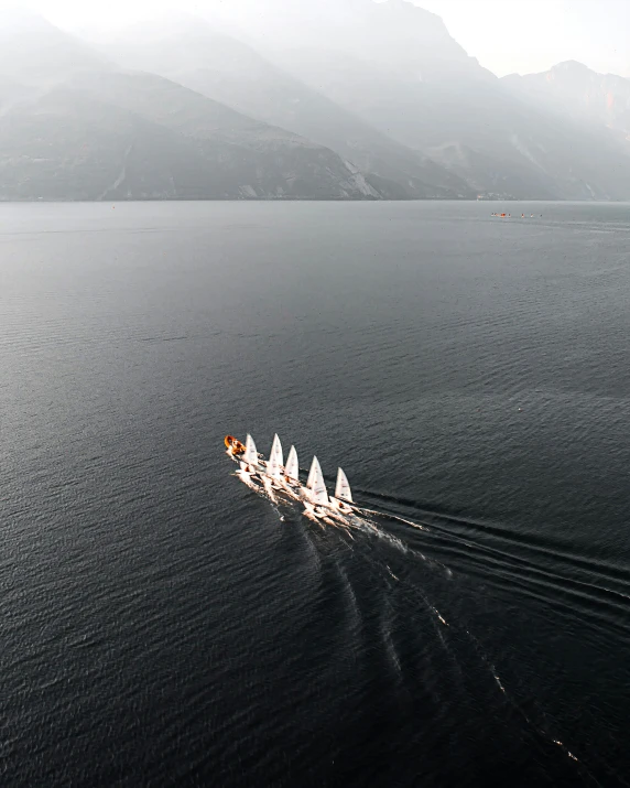 four boats are lined up in the water