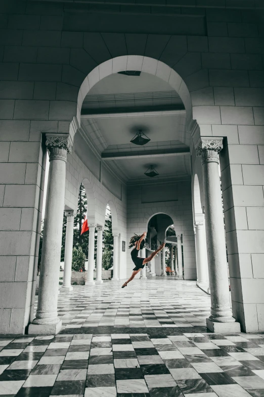 a skateboarder is riding through a beautiful corridor