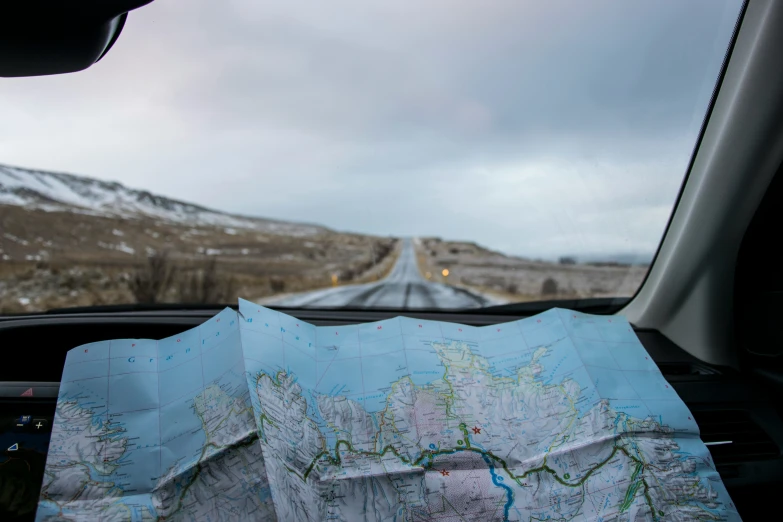 a map and some trees in the middle of a road