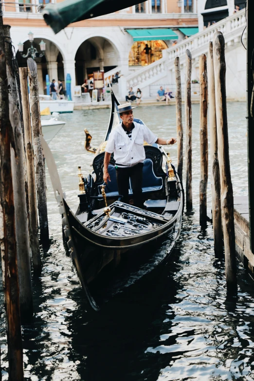 two people are sitting in a gondola on the water