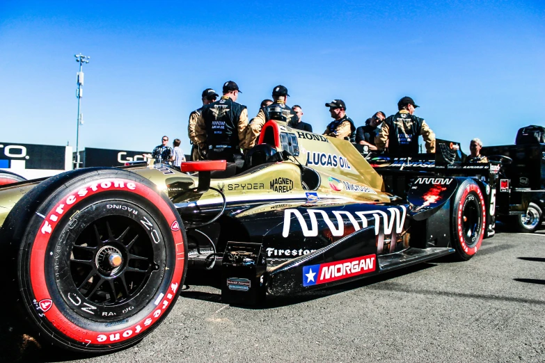 two drivers sit in a racing car at the drag track