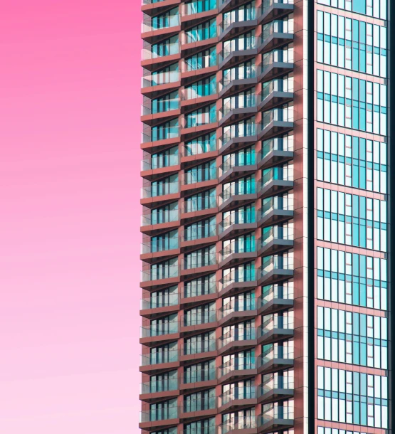 a tall building with balconies in front of a red and pink sky