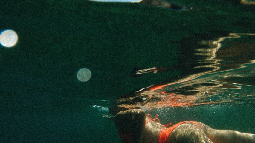 a  swimming in the water with a surf board