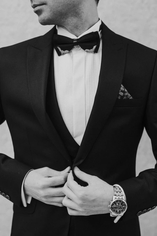 a close up of a person wearing a suit and bow tie