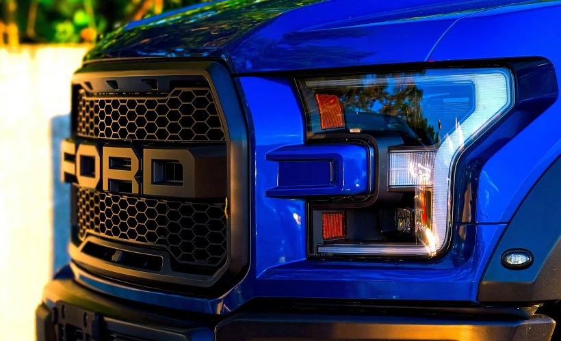 a blue truck parked on the side of a road