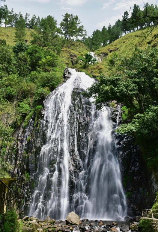 this water fall is on the side of a mountain