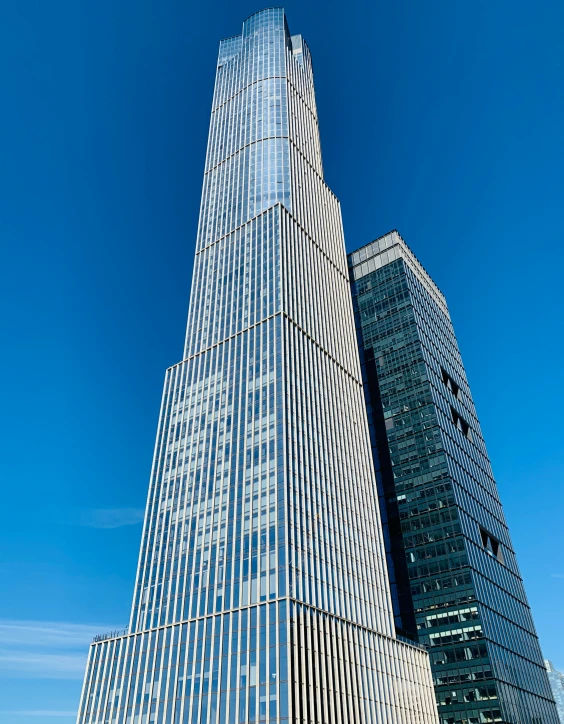 tall buildings with windows are against a blue sky