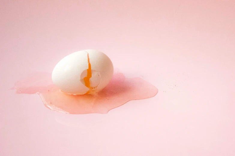 an orange substance floating on top of a white egg