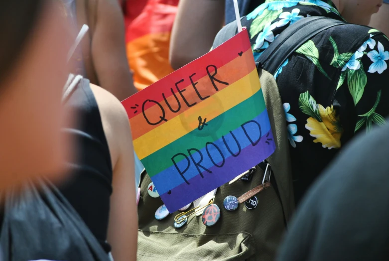 a sign that reads queen and proud at an event