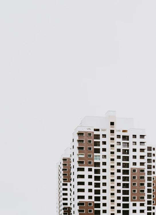 a group of apartment building that has a large clock at the top