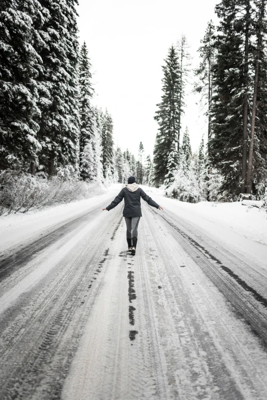 there is a woman walking through a snowy road