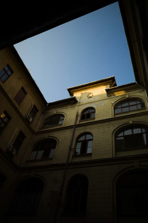 the roof of a building with two open windows