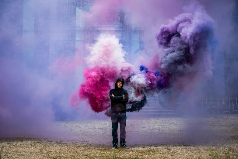 person in black jacket holding colored object while standing