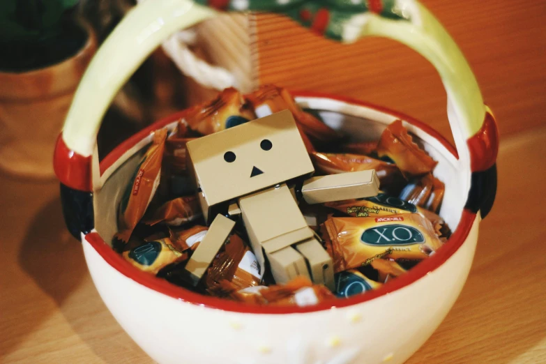 the toy robot has just been put into a mug of candy