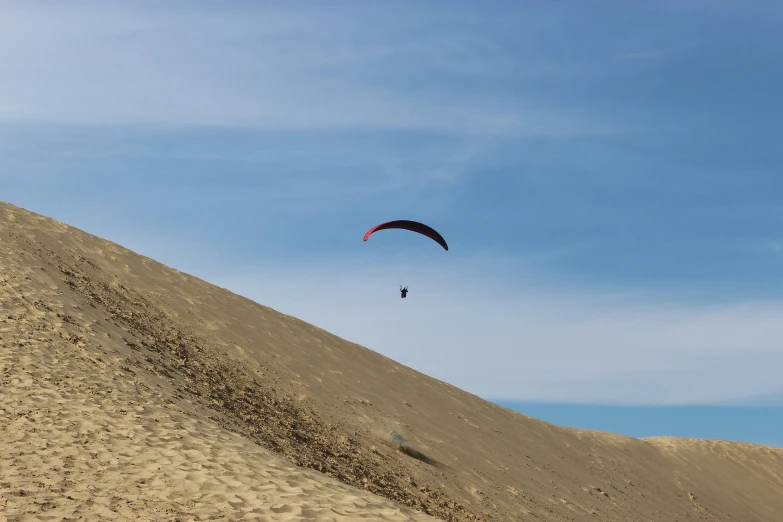 a person para - sailing on the top of a very tall mountain