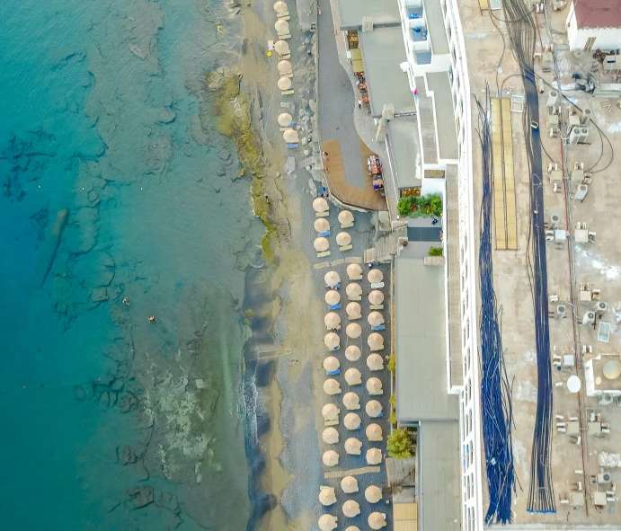 a beach resort with a line of beach umbrellas