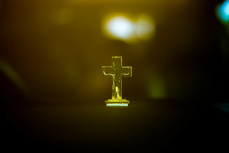 a yellow cross with a blurred background on the table