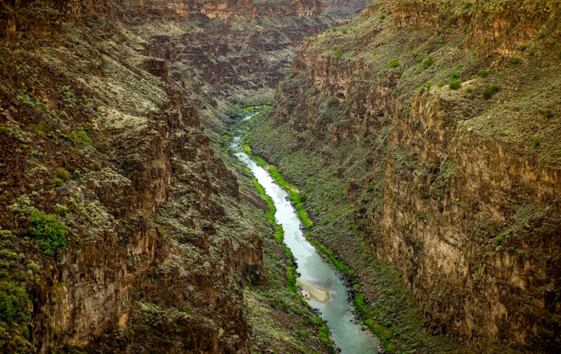 a narrow river in the middle of a mountainside