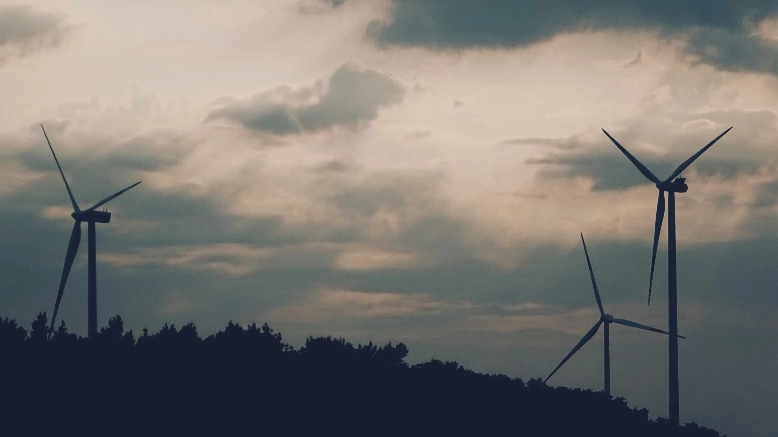 there is a group of wind turbines standing together