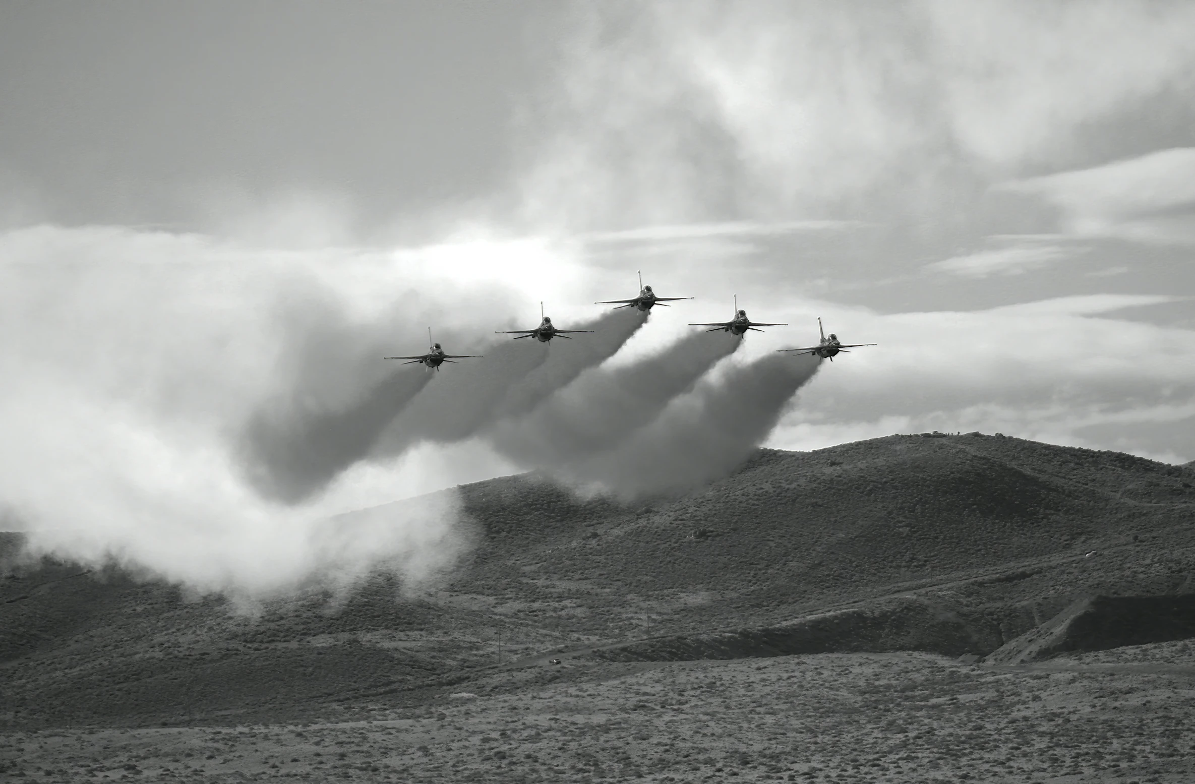 black and white image of four planes flying in formation