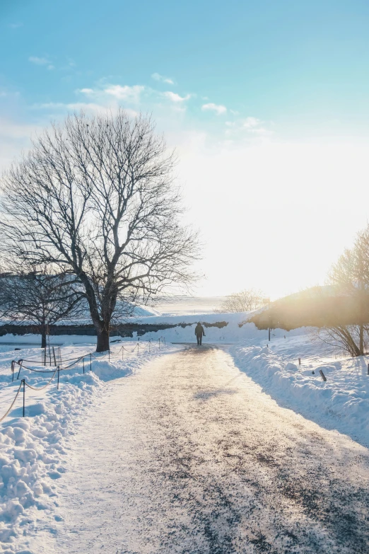 a walk way that is covered in snow and snowing