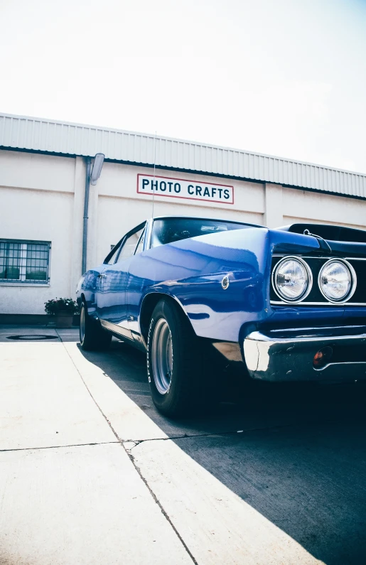 the old car is parked outside of the building