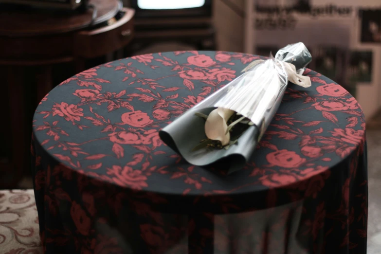 a roll of paper is wrapped over a small table