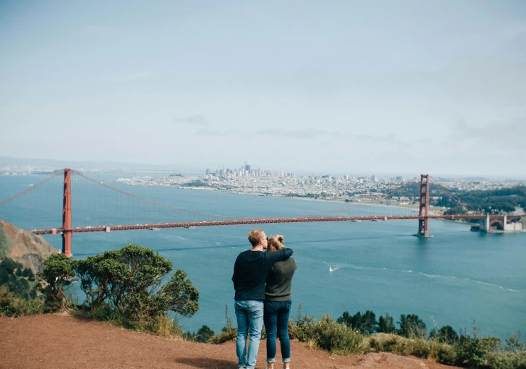 the two people are looking out at the beautiful city