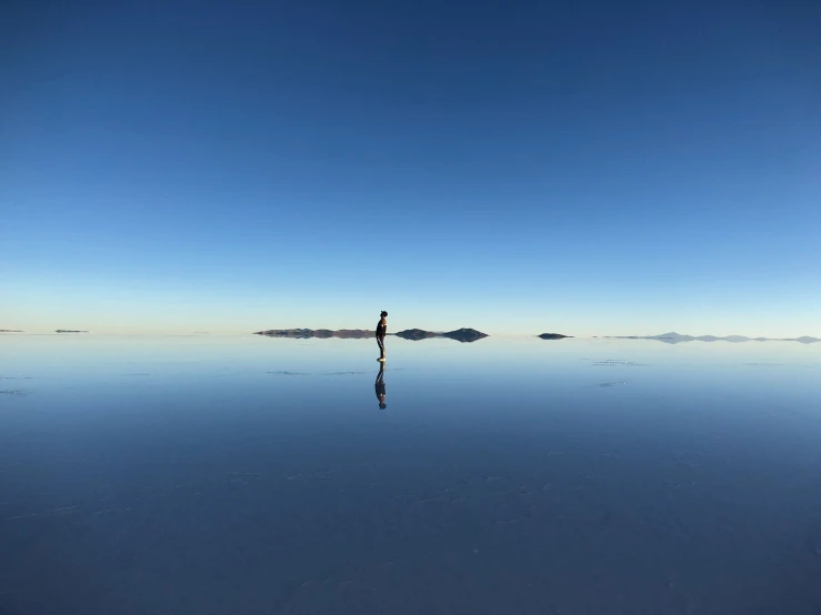 a person standing on the edge of a body of water