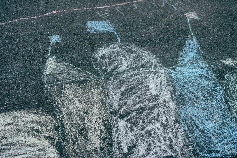 chalk drawing on surface showing people holding umbrellas