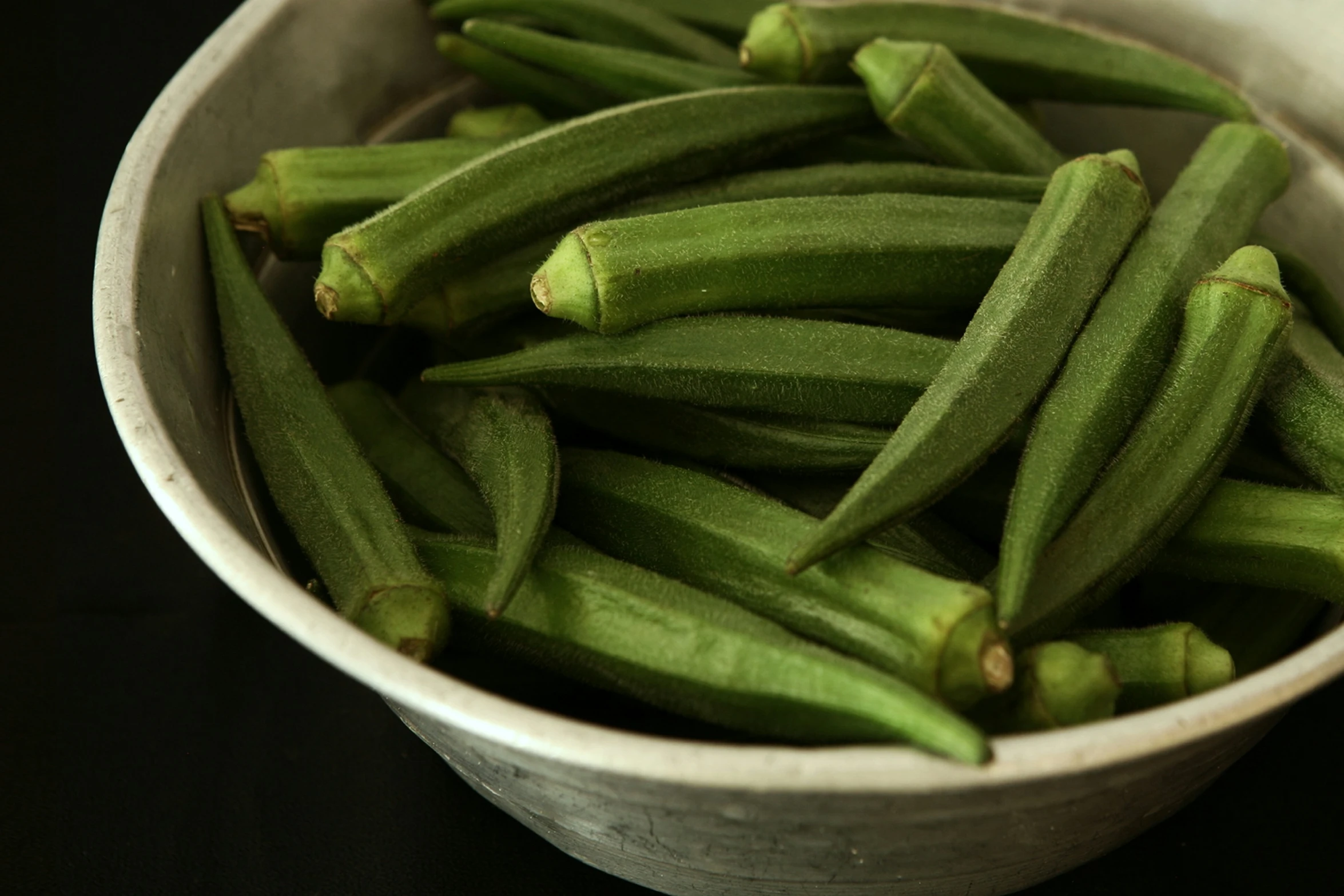 a white bowl filled with a green bean