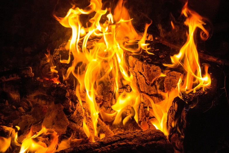 flames and rocks in a fireplace that is open