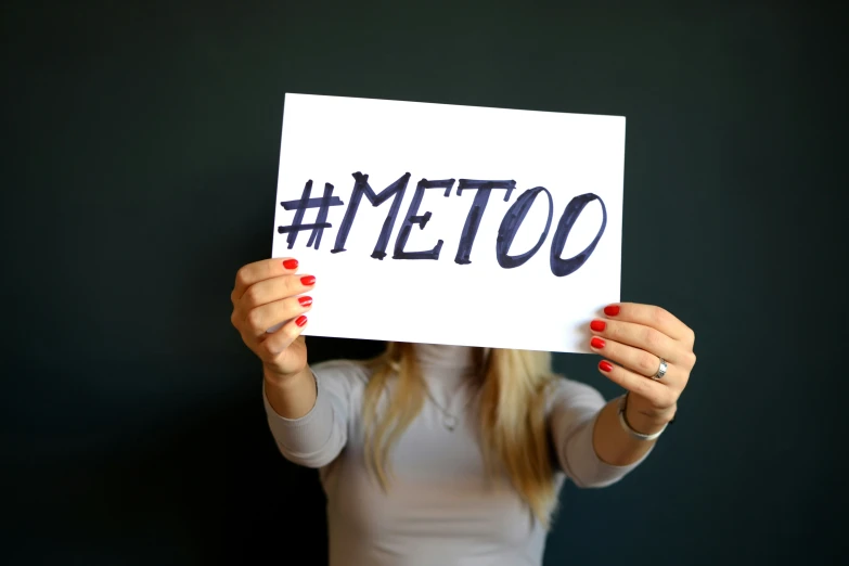 a woman is holding a sign with the word metto