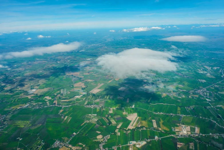 a view from an airplane on the wing above the clouds