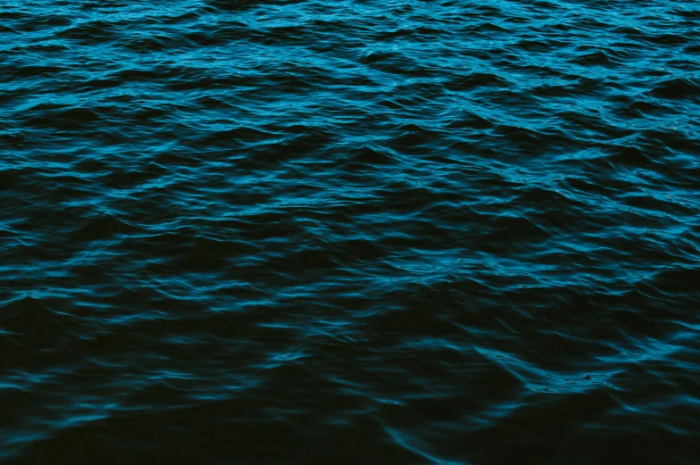 a man sailing on a boat in a large body of water