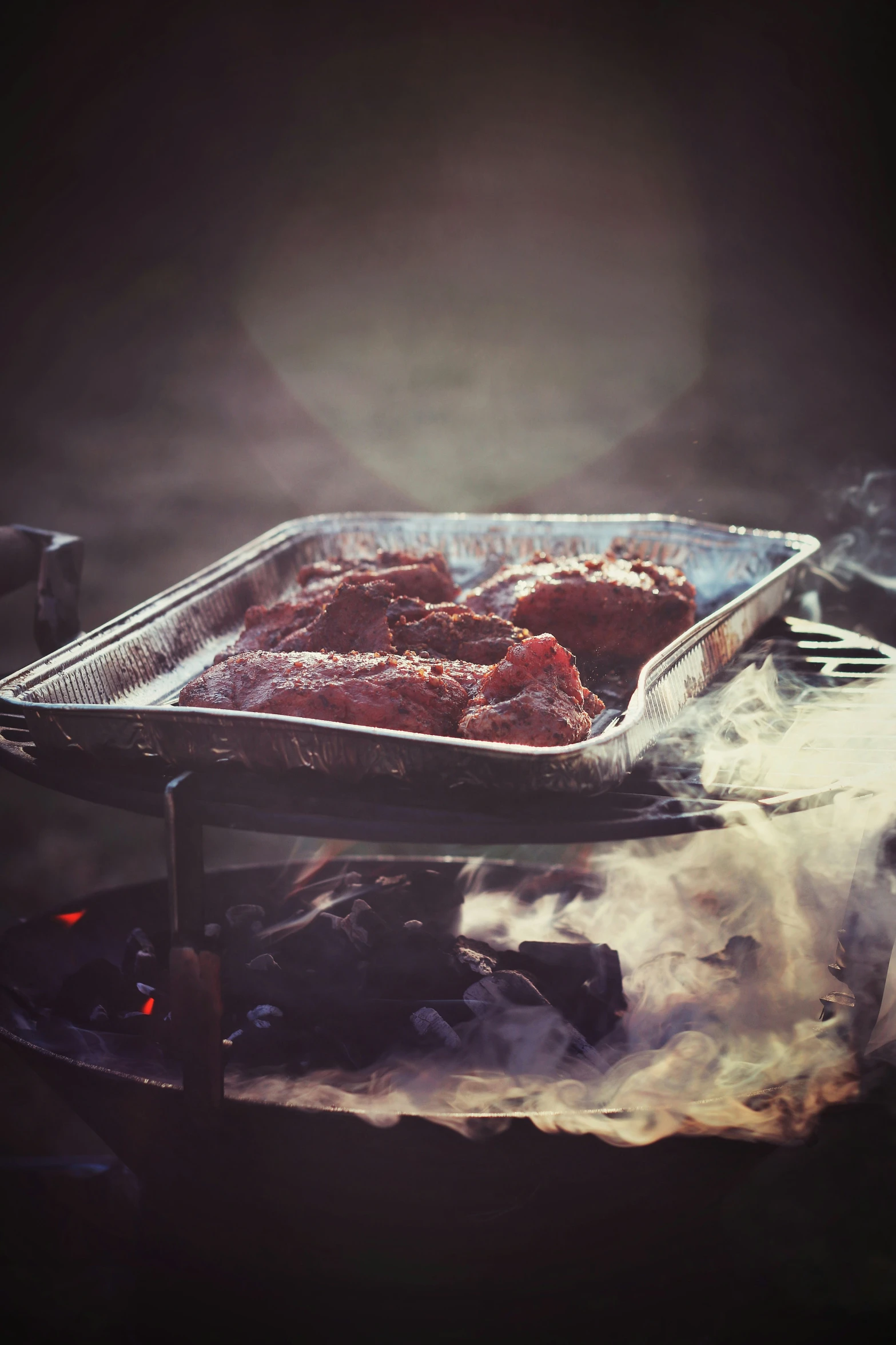 sausages being cooked over the grill on an outdoor stove