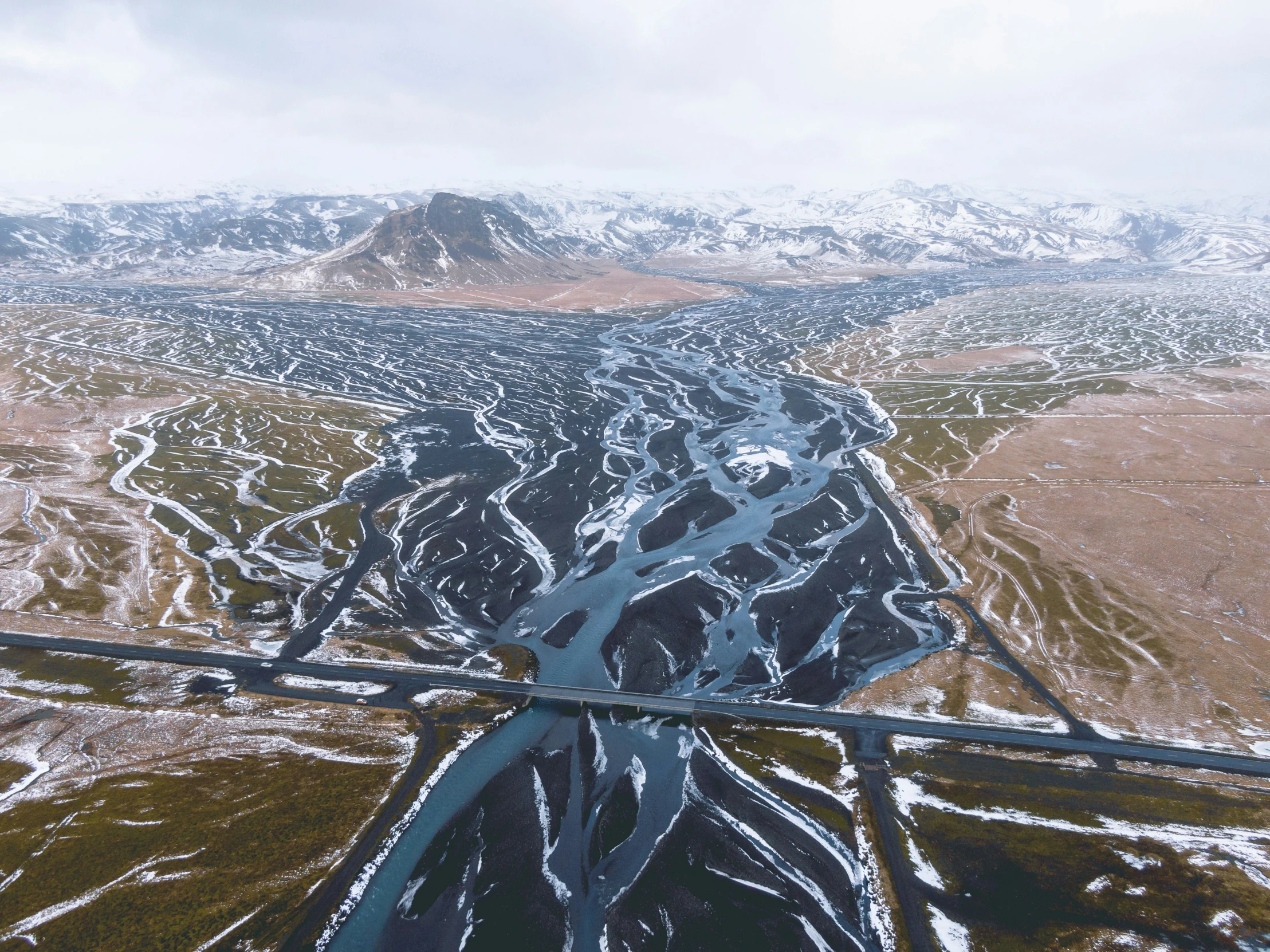 a large body of water surrounded by snowy mountains