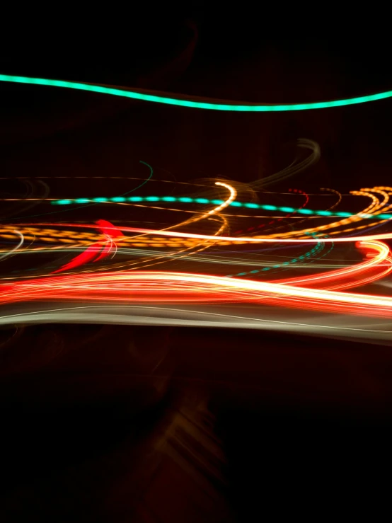 blurred pograph of some cars at night with colored lights