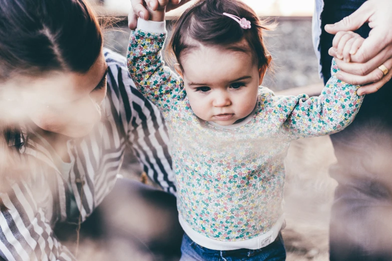 an adorable little girl holding onto her mother