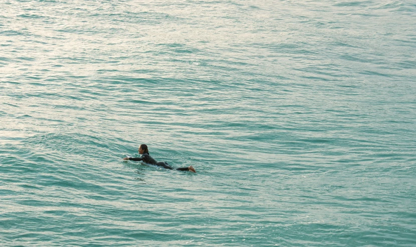 a person in the water with a surfboard