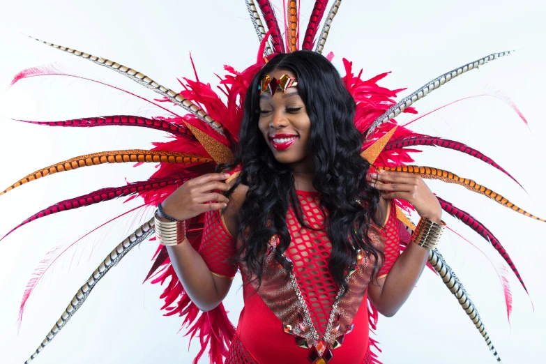 a woman in red feathers holding up her umbrella