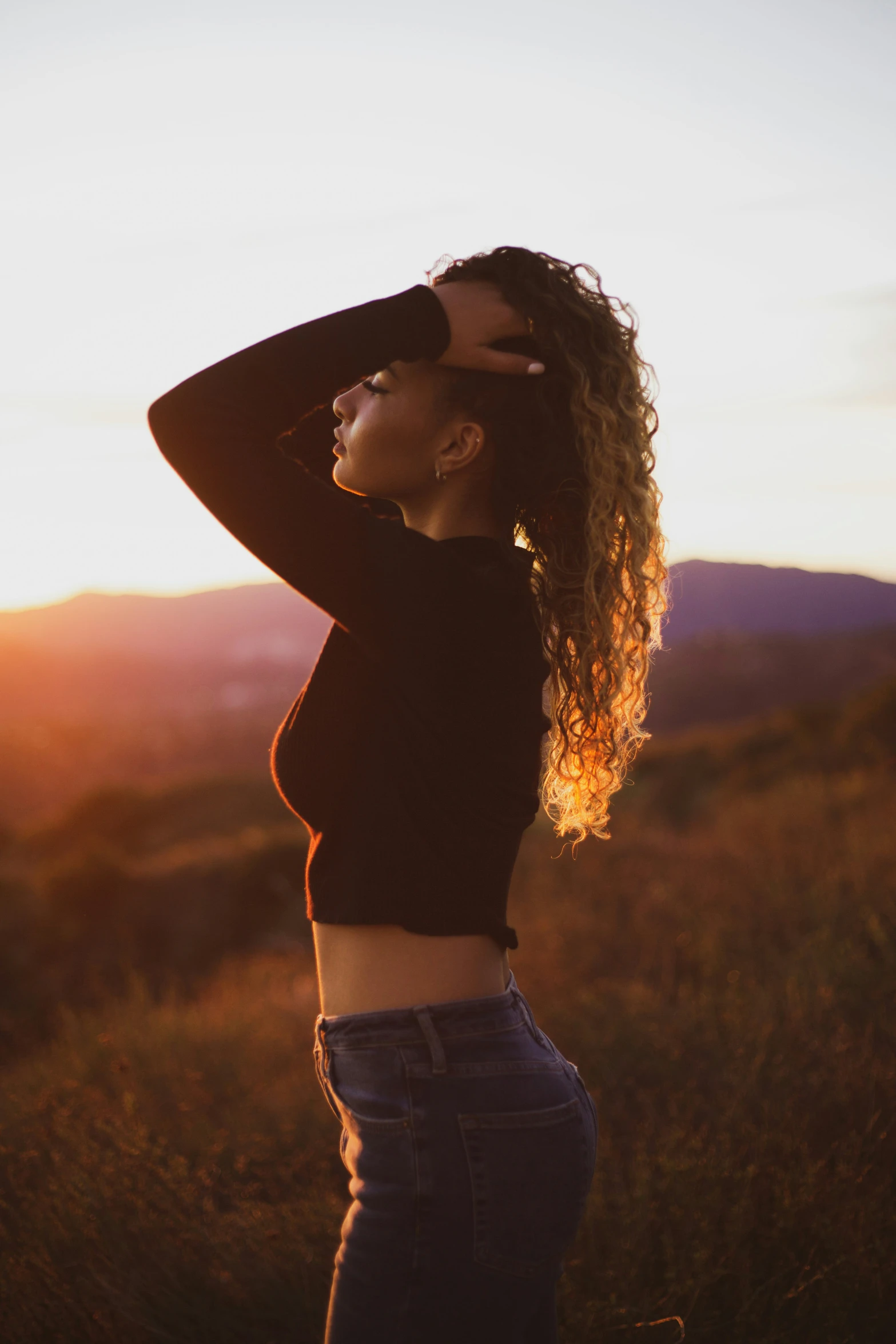 a woman that is standing in the grass