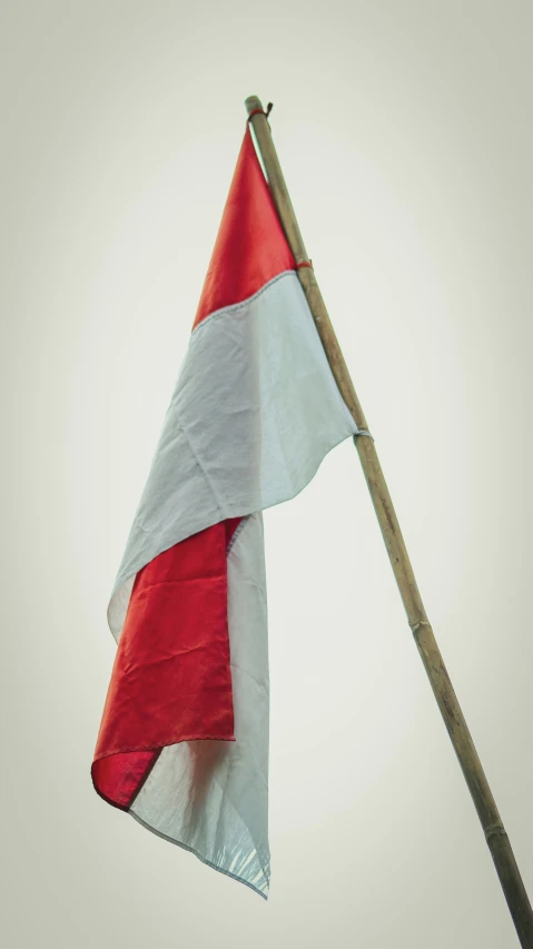 a red and white kite flying in the air