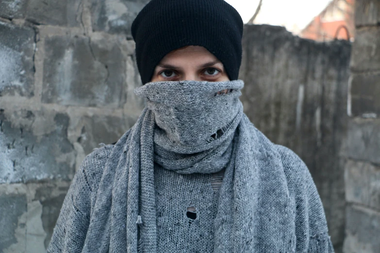 a person with a scarf wrapped around their face