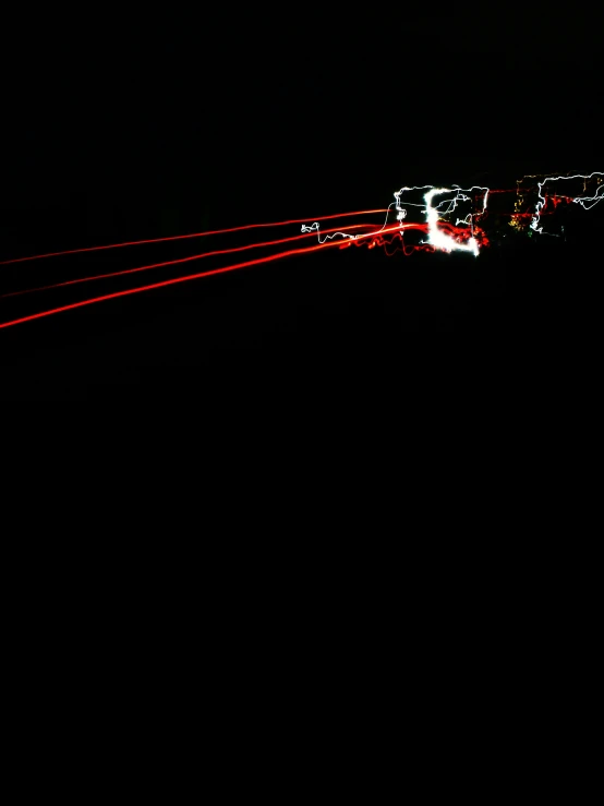 a black night showing the light trail on the gondola